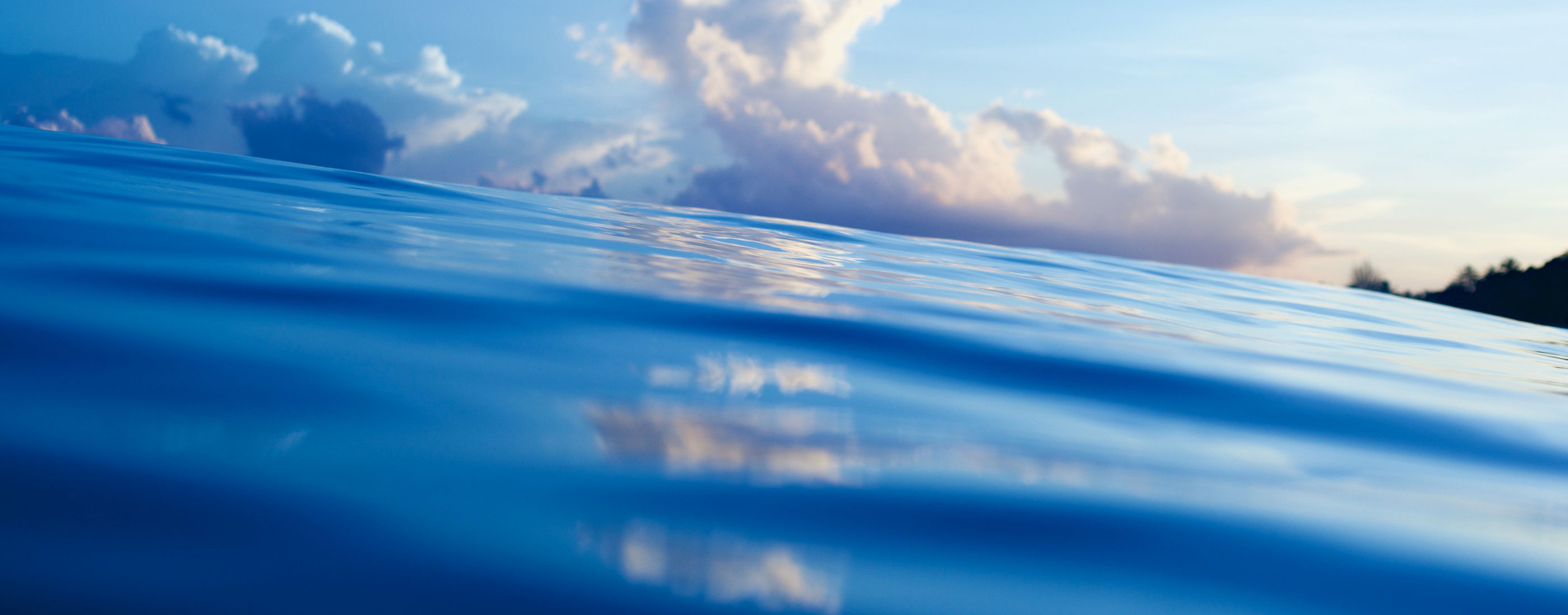 view of water with clouds in the background